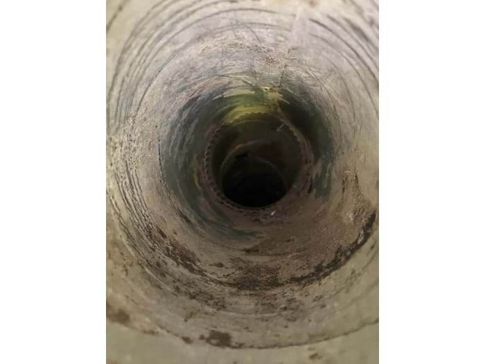 Expert cleaning a dryer vent to remove lint buildup and enhance safety and efficiency in a home.